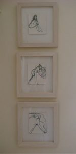 3 small framed drawings of abstracted figures
