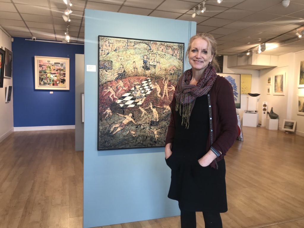 photo of artist with work at clifton gallery