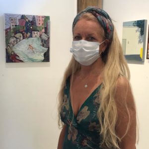 artist with painting exhibition